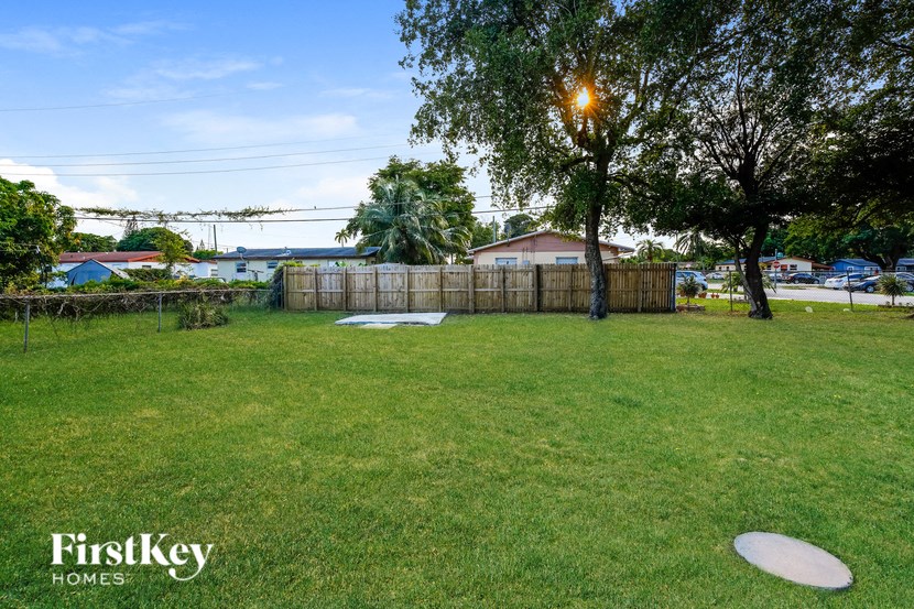 A grassy yard with a FirstKey Homes logo.
