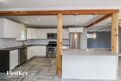 a modern kitchen with white cabinets and stainless steel appliances