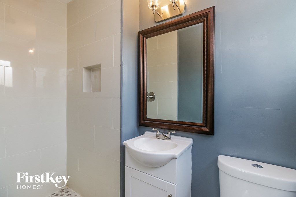 a small bathroom with a sink and mirror and a toilet