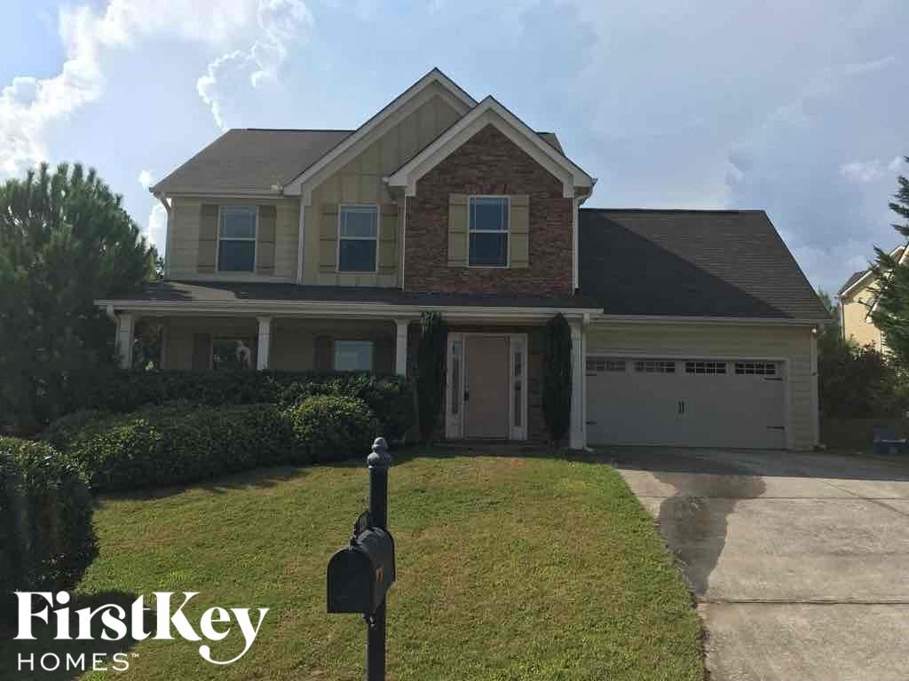 a house with a driveway and a mailbox in front of it