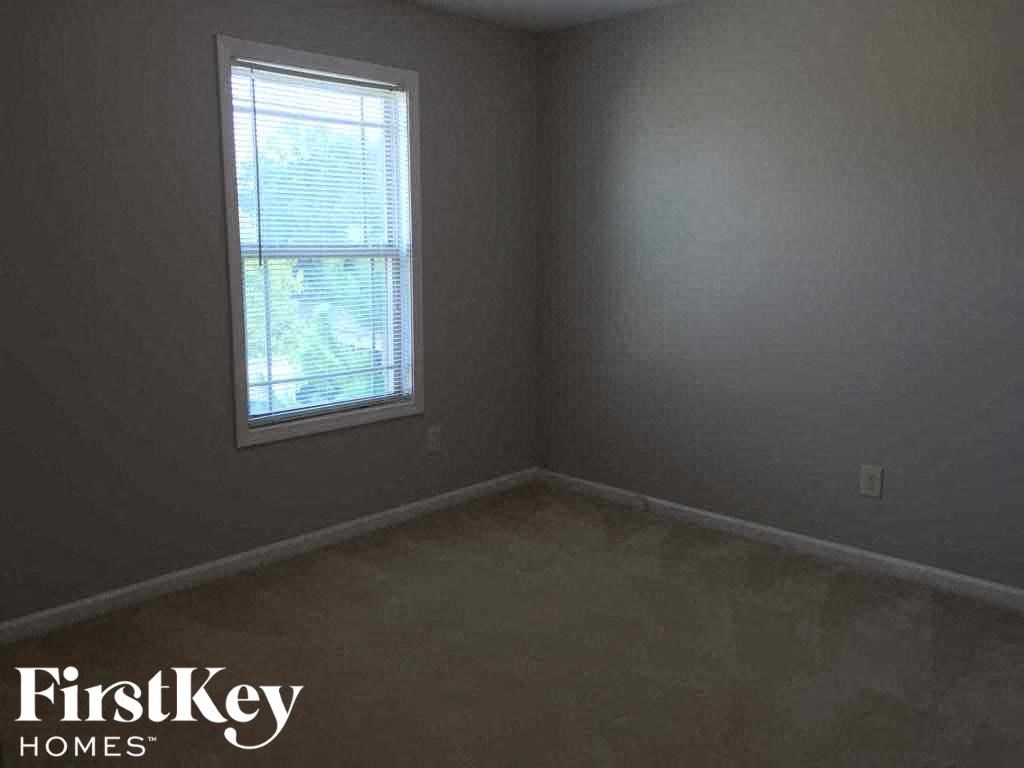 a room with a window and a carpeted floor