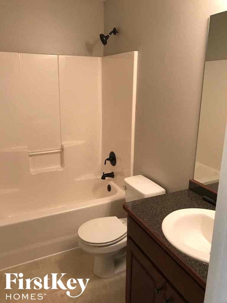 a white bathroom with a sink toilet and tub
