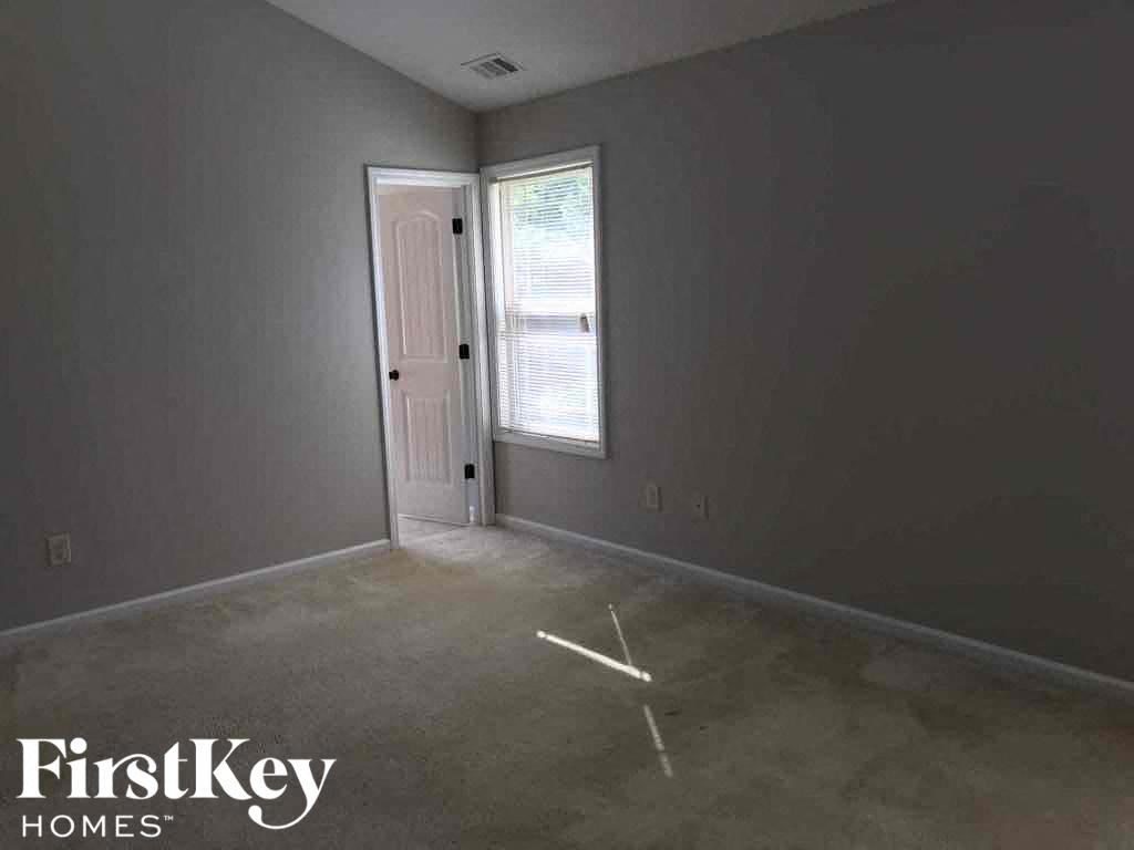 an empty room with a door and a window