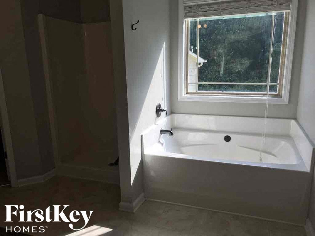 a bathroom with a bath tub and a window