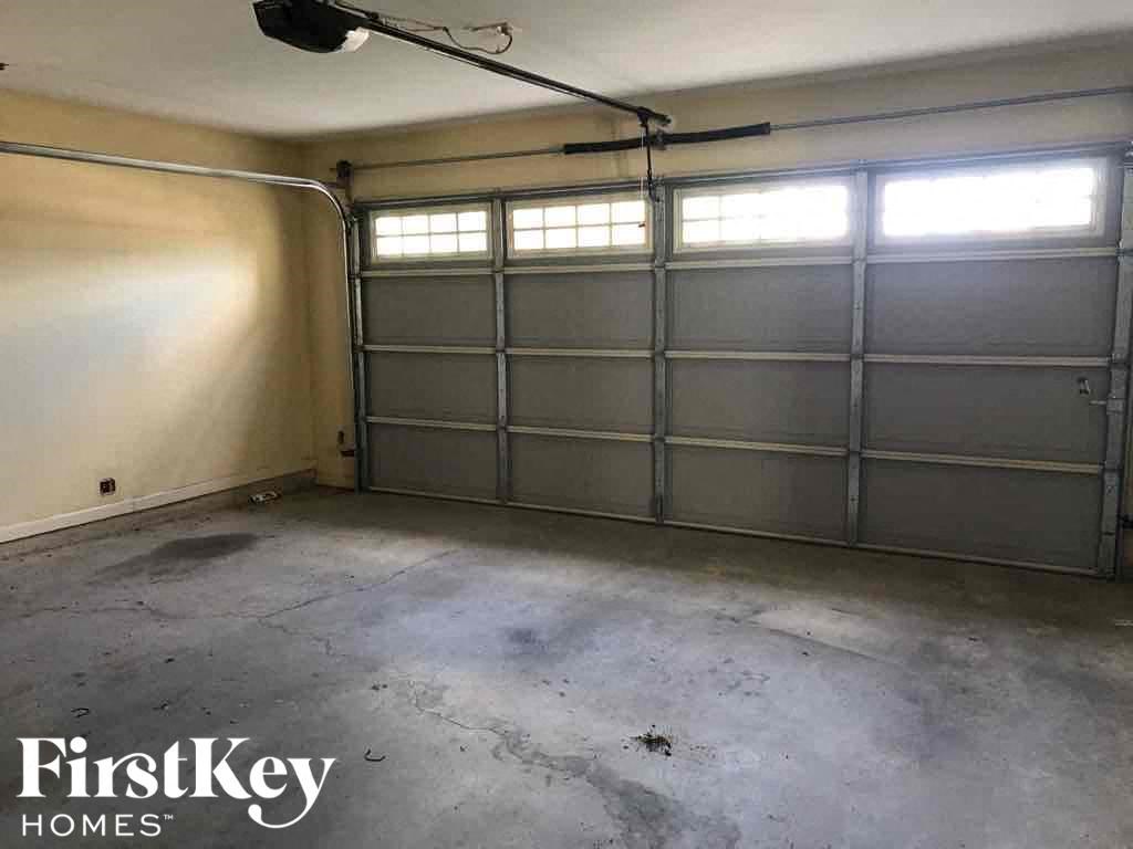 a garage door is closed on a white wall in a garage
