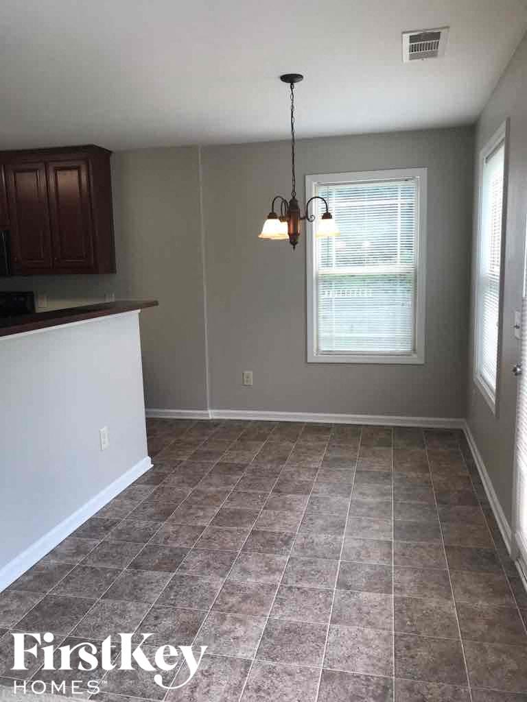 an empty kitchen and dining room with a window