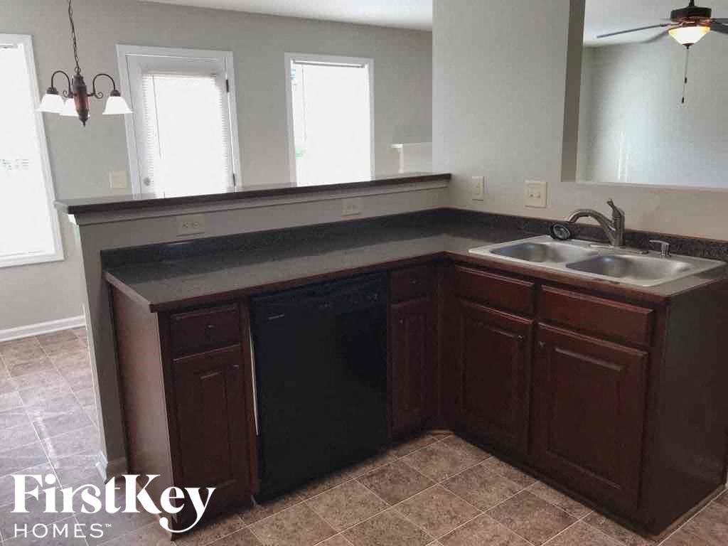 an empty kitchen with a sink and a counter top