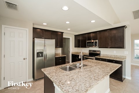 a kitchen with granite counter tops and stainless steel appliances