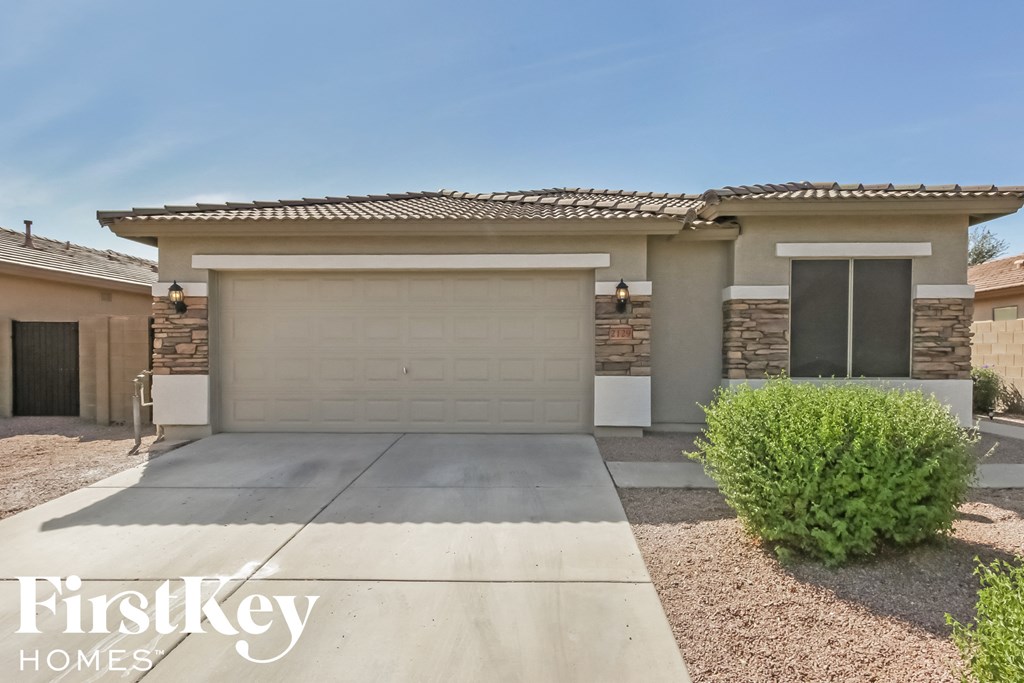 a single story home with a garage door and a driveway
