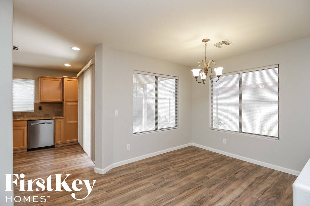 a kitchen and living room with wood flooring and a chandelier