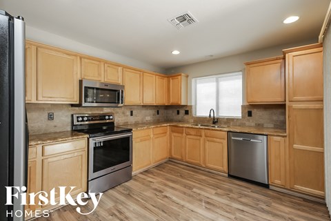 a kitchen with wooden cabinets and stainless steel appliances