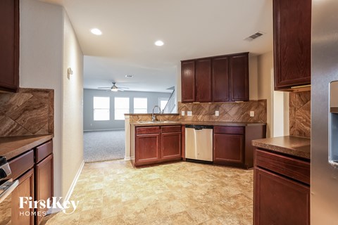 a kitchen with brown cabinets and a white counter top