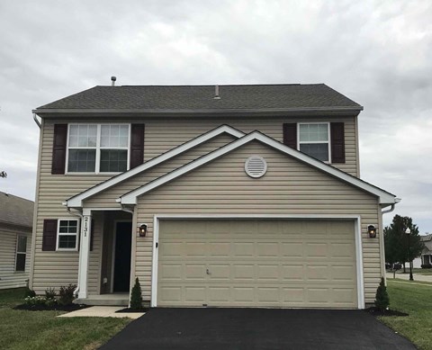 the front of a house with a garage door