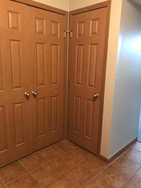 a pair of doors in a room with a tile floor