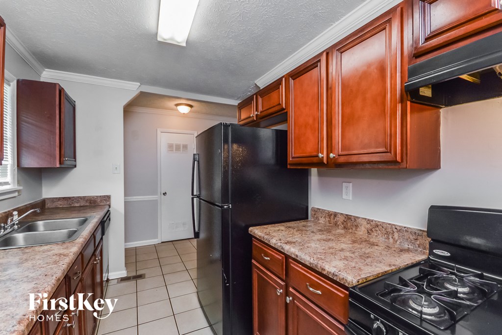 a kitchen with black appliances and brown cabinets