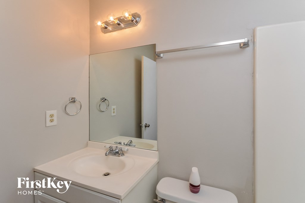 a small bathroom with a sink and a mirror and a shower