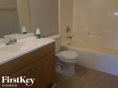 A white toilet sits next to a sink in a bathroom.