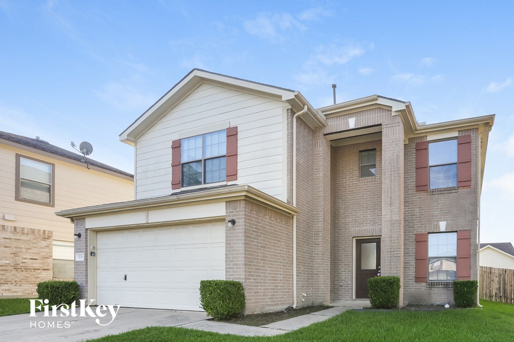 a brick and with a white garage door