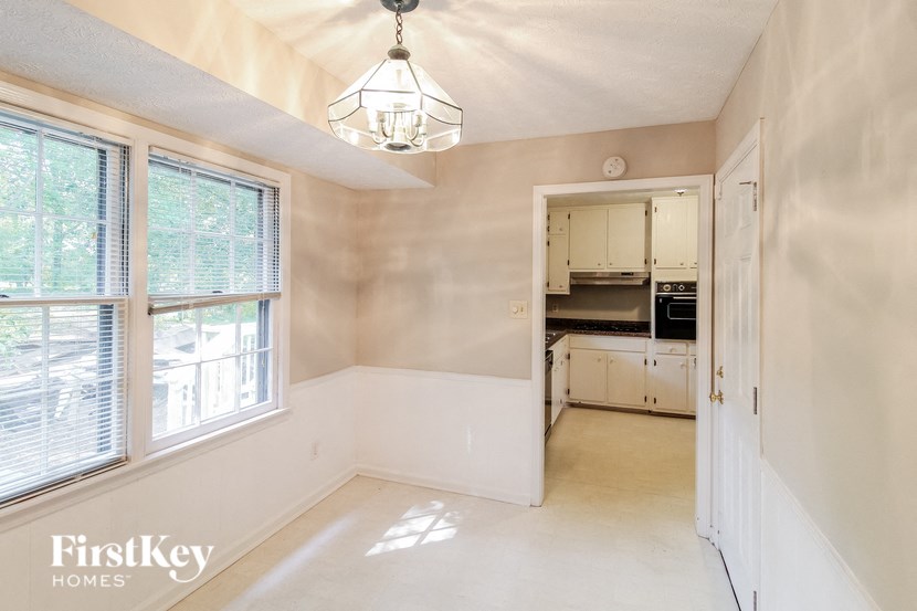 a small kitchen with a large window and a door