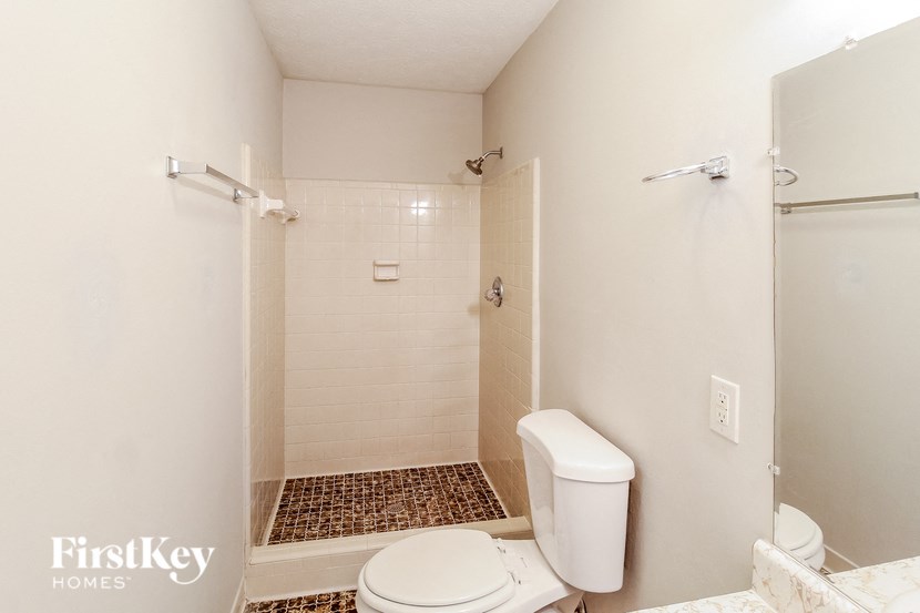 a small bathroom with a toilet and a shower