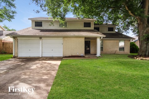 a white brick house with a white garage door