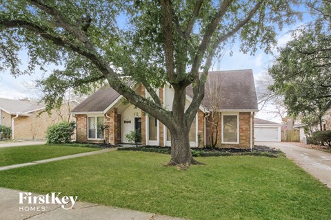 A house with a tree in front of it.