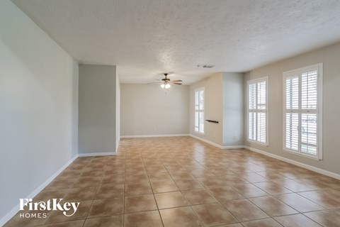A room with a tile floor and a ceiling fan.