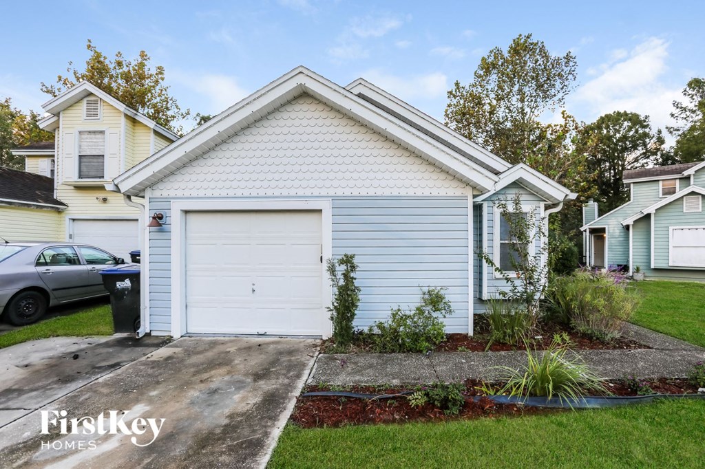 a small white house with a white garage door