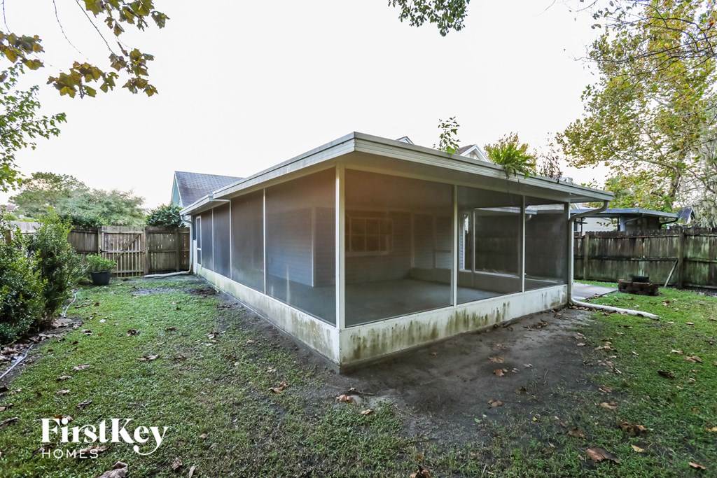 the back of a screened in porch of a home