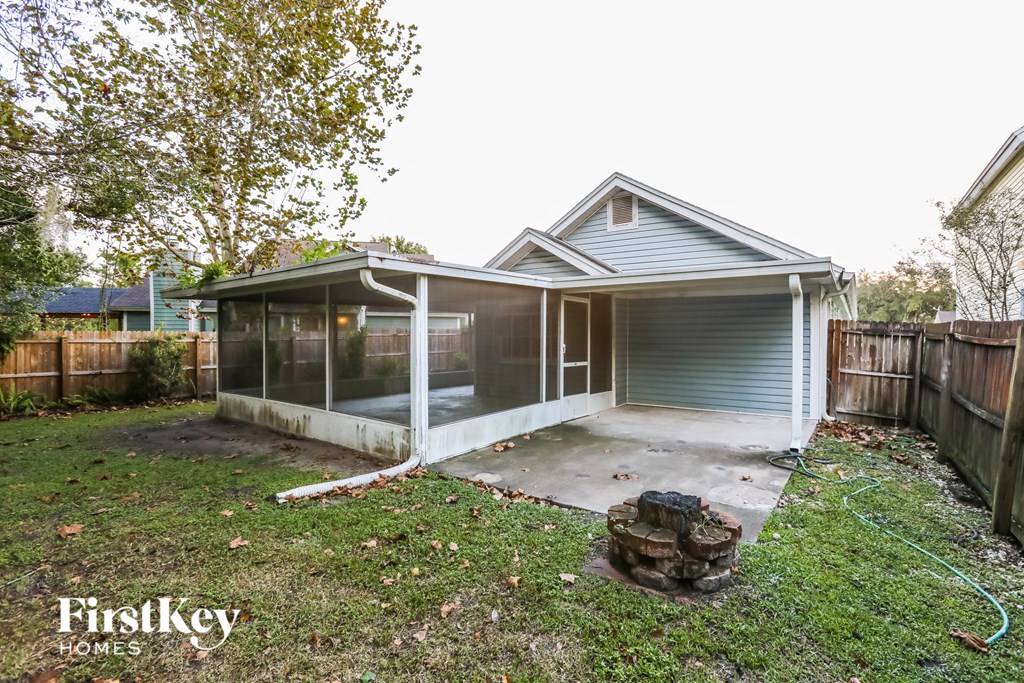 a backyard with a screened in porch and a house