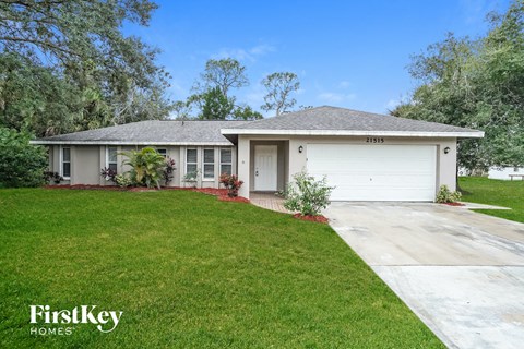 a white house with a lawn and a white garage door