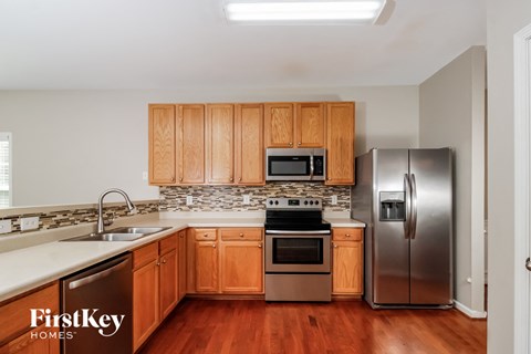 a kitchen with wooden cabinets and stainless steel appliances