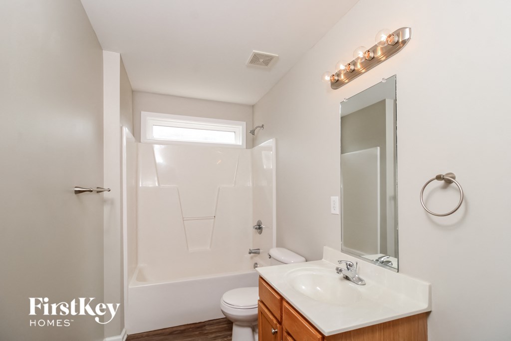 a bathroom with a sink and a toilet and a shower