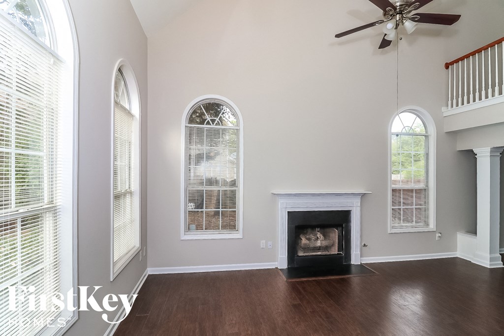 a living room with a fireplace and large windows