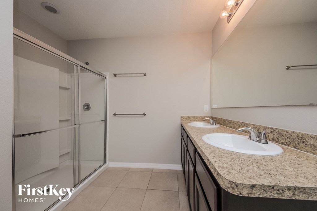 a bathroom with a sink and a shower in it