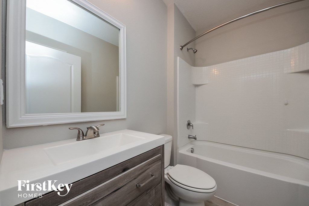 a bathroom with a toilet and a sink and a mirror