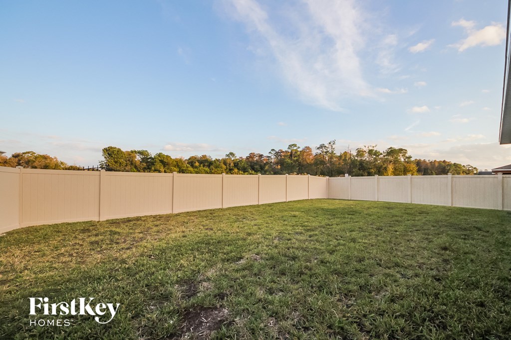 a fisheye view of a backyard with a fence and green grass