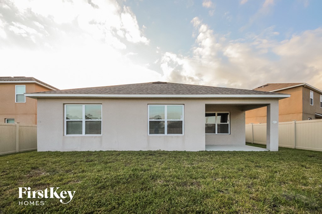 a white house with a lawn in front of it