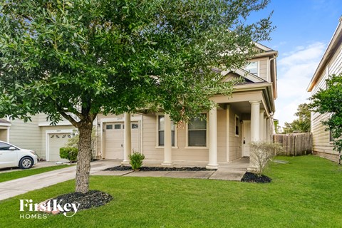 a home with a tree in the front yard