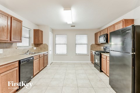 a kitchen with wooden cabinets and stainless steel appliances