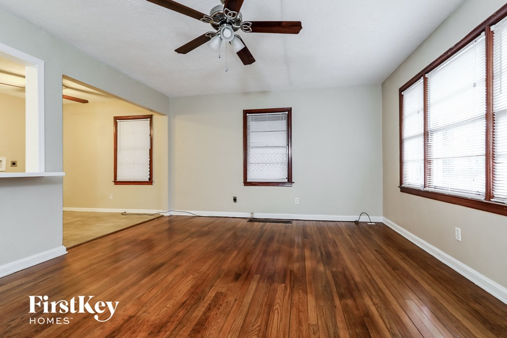 A room with wooden floors and a ceiling fan.