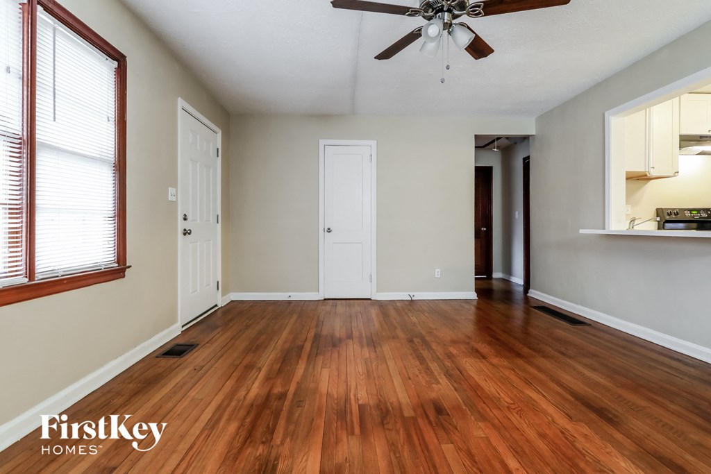 A room with wooden floors and a ceiling fan.