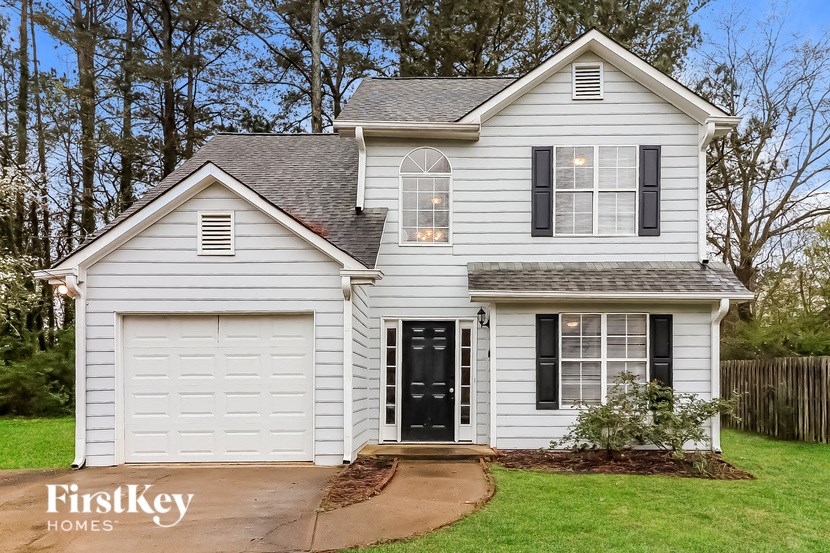 A house with a garage and a black door.