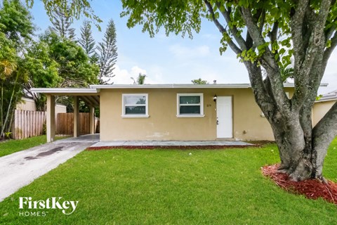 A house with a tree in front of it.
