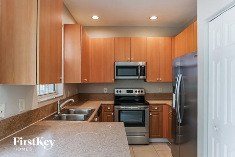 A kitchen with wooden cabinets and stainless steel appliances.