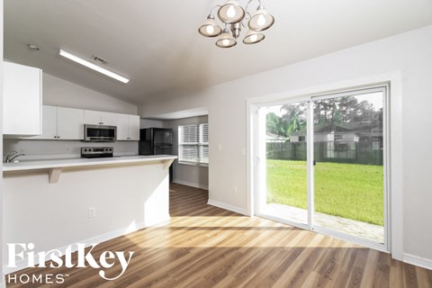 A kitchen with a white counter top and a microwave.
