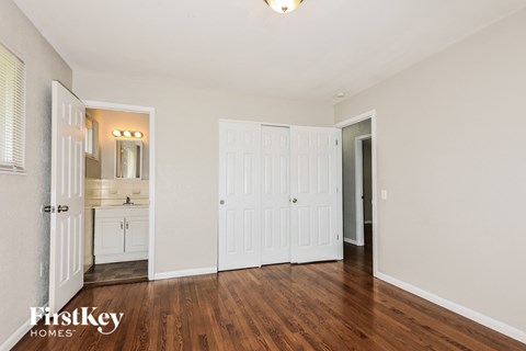 a bedroom with two closets and a door to a bathroom