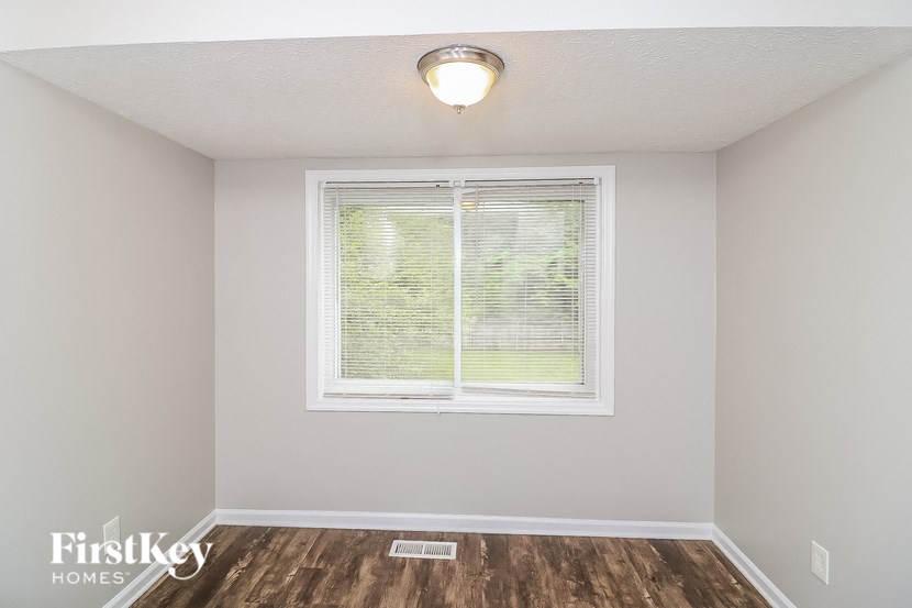the living room of an empty house with a window