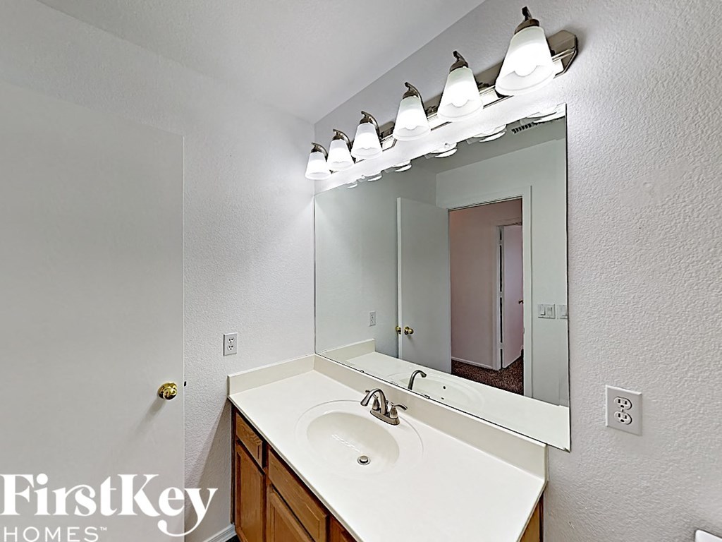 a bathroom with a white sink and a mirror