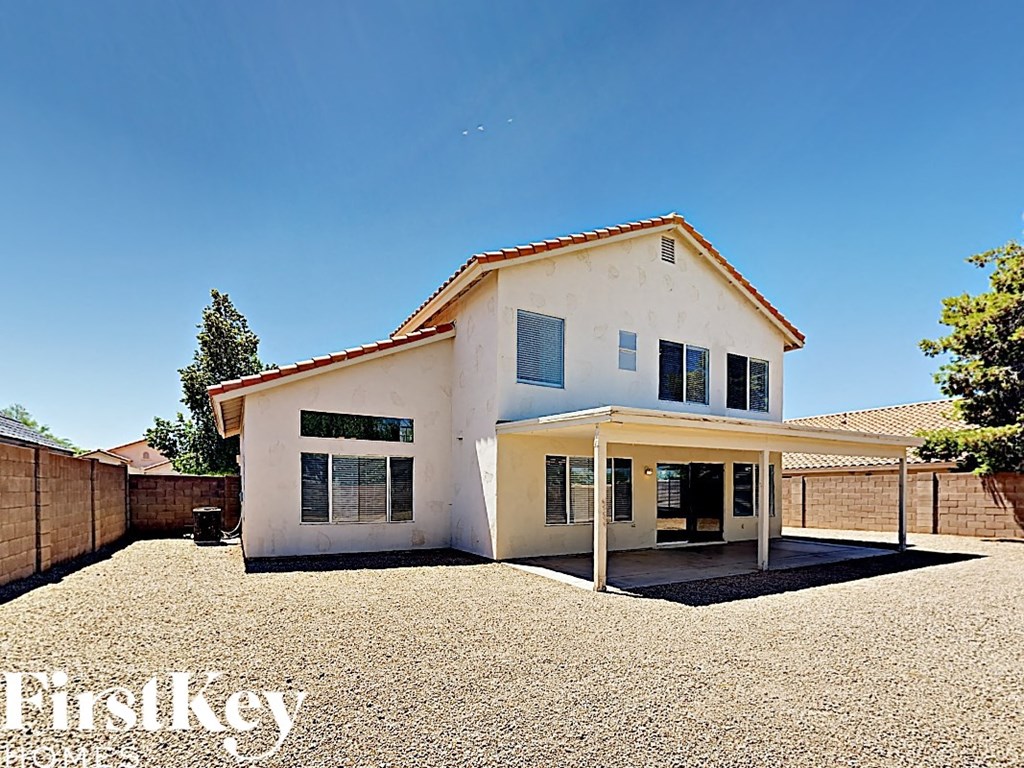 a white house with a yard and a driveway